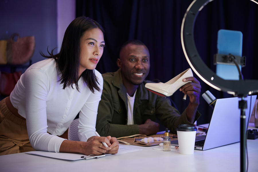 Online shop owners streaming video and answering questions about products